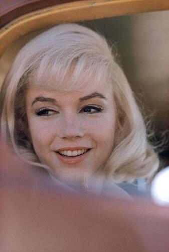 Marilyn looking out vehicle window 1959